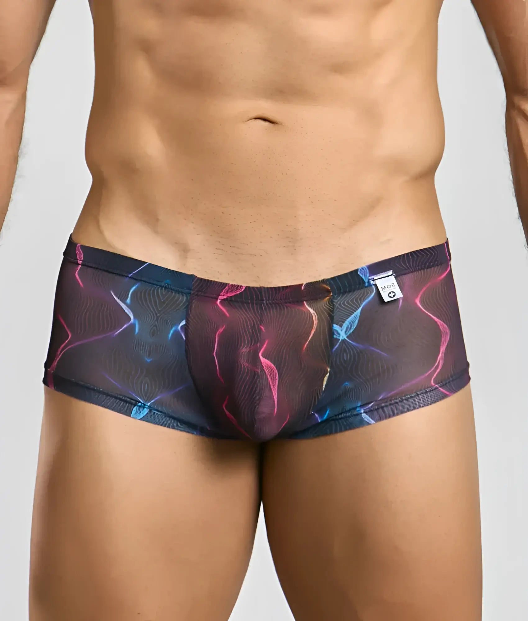 MOB men’s sexy sheer hip brief in black mesh with vibrant pink blue and purple neon lightning bolt pattern