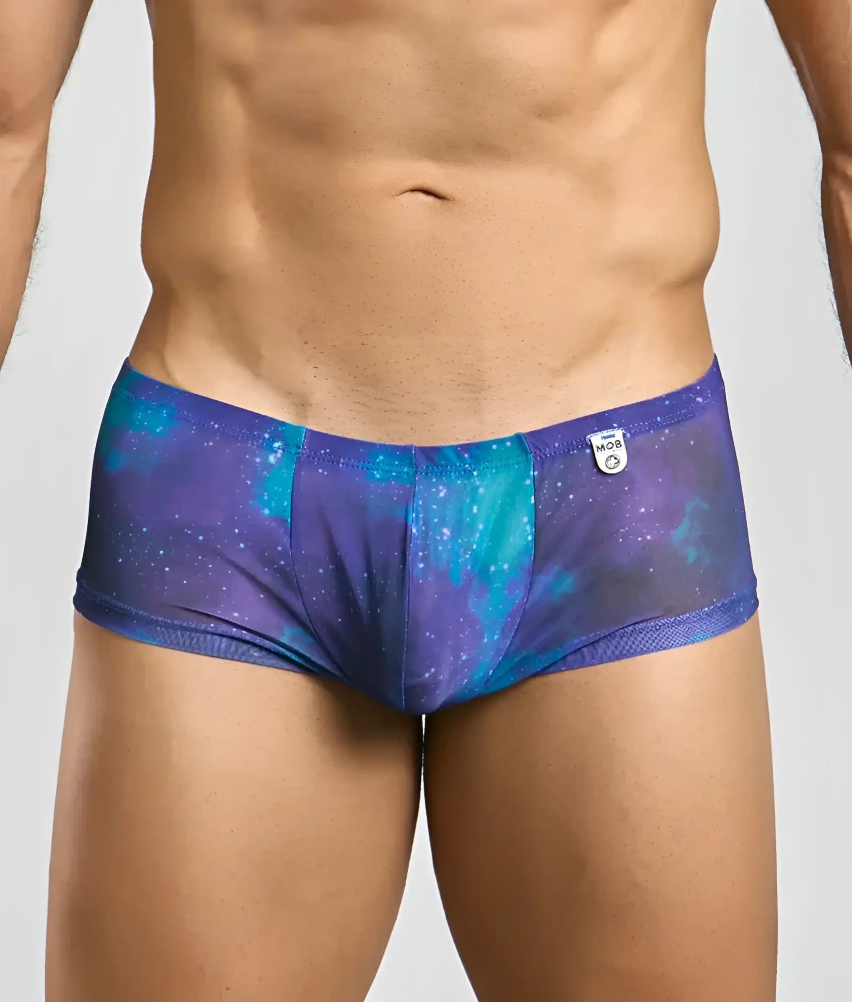 Mob men’s sexy sheer hip brief in purple and teal galaxy pattern with mesh trim and sheer fabric design