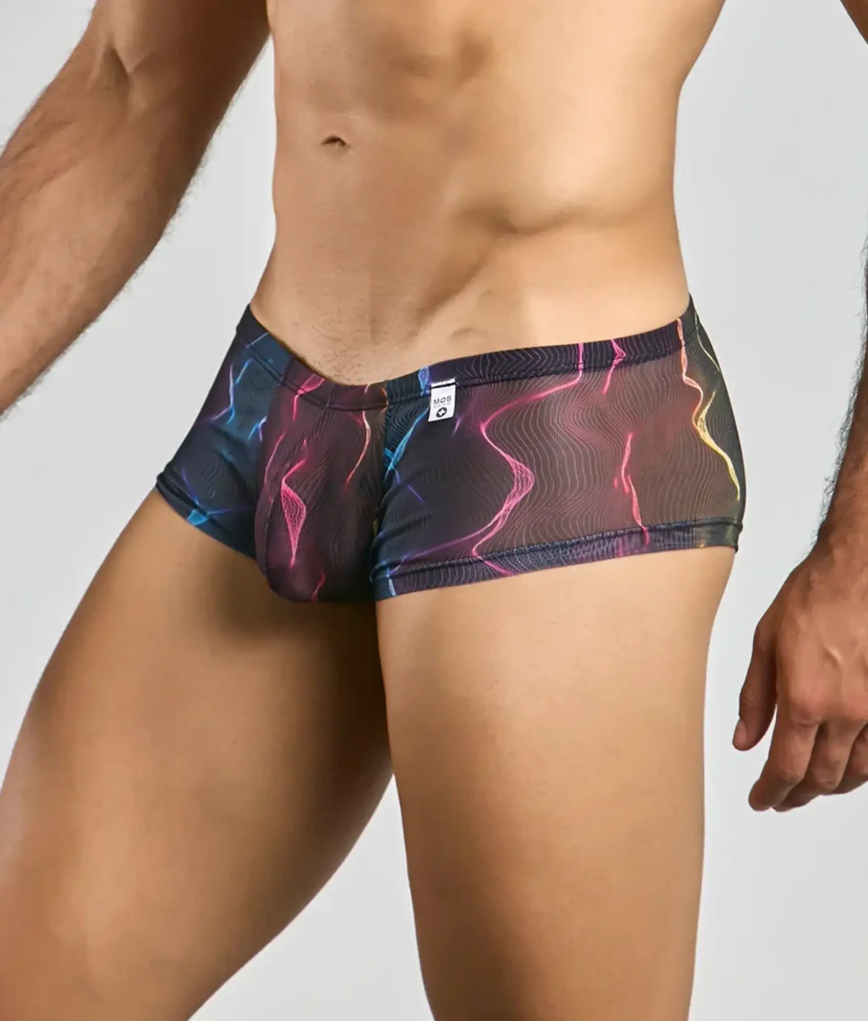 Mob men’s sexy sheer hip brief in vibrant electric pink blue and yellow lightning-patterned mesh fabric