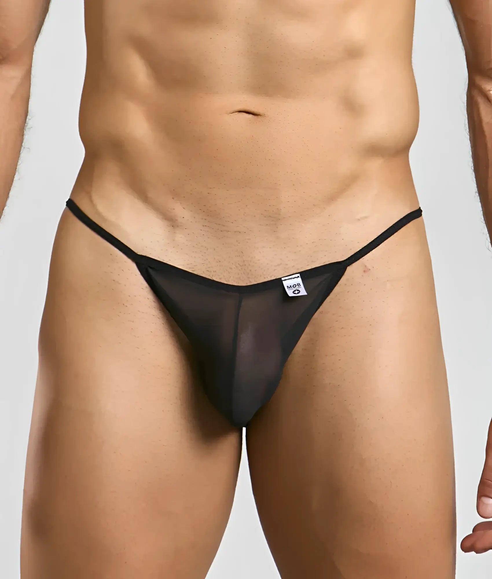 Black sheer mesh thong with thin elastic waistband and small white mog men’s sheer bikini brand tag visible