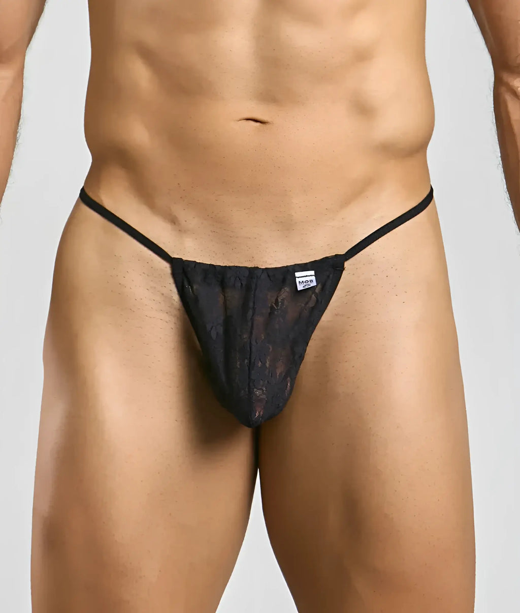 Black lace thong g-string with thin straps and small brand tag at waistband shown from the back in MOB Print New collection