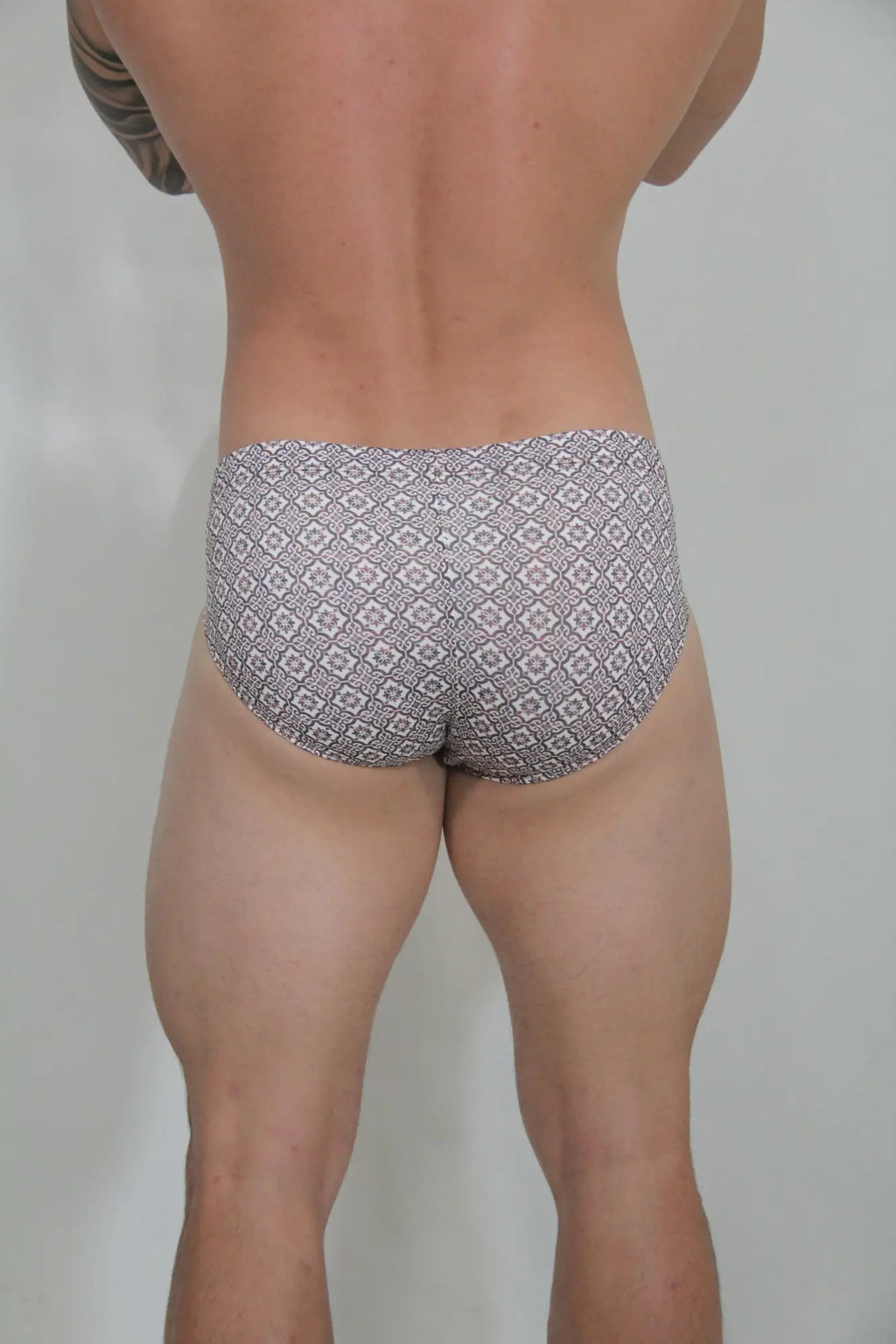 Gray and white patterned mosaico swim brief with geometric design in a lightweight fabric for swimming