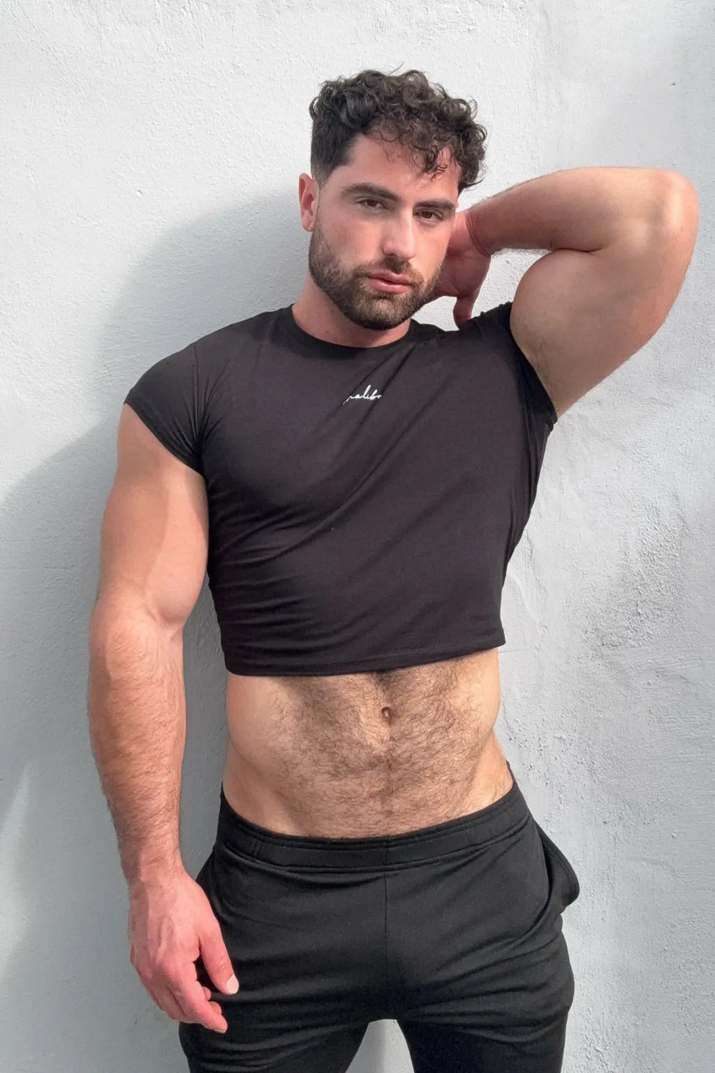 Black muscle-fit crop half-sleeve t-shirt with small white logo on chest made of soft breathable fabric