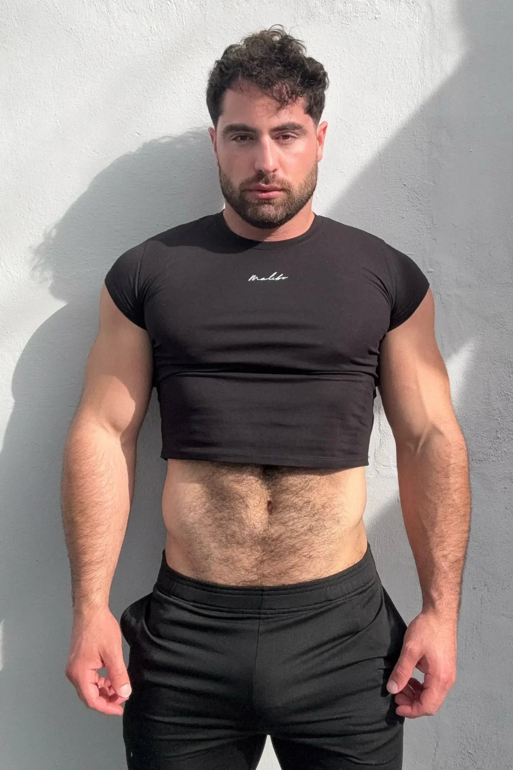 Black muscle-fit crop short-sleeve t-shirt with small white embroidered logo on the chest for casual wear