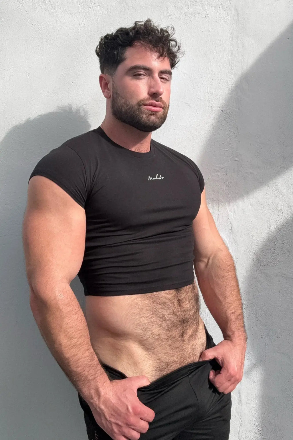 Black muscle-fit crop half-sleeve tee with short sleeves and subtle white chest logo perfect for casual wear