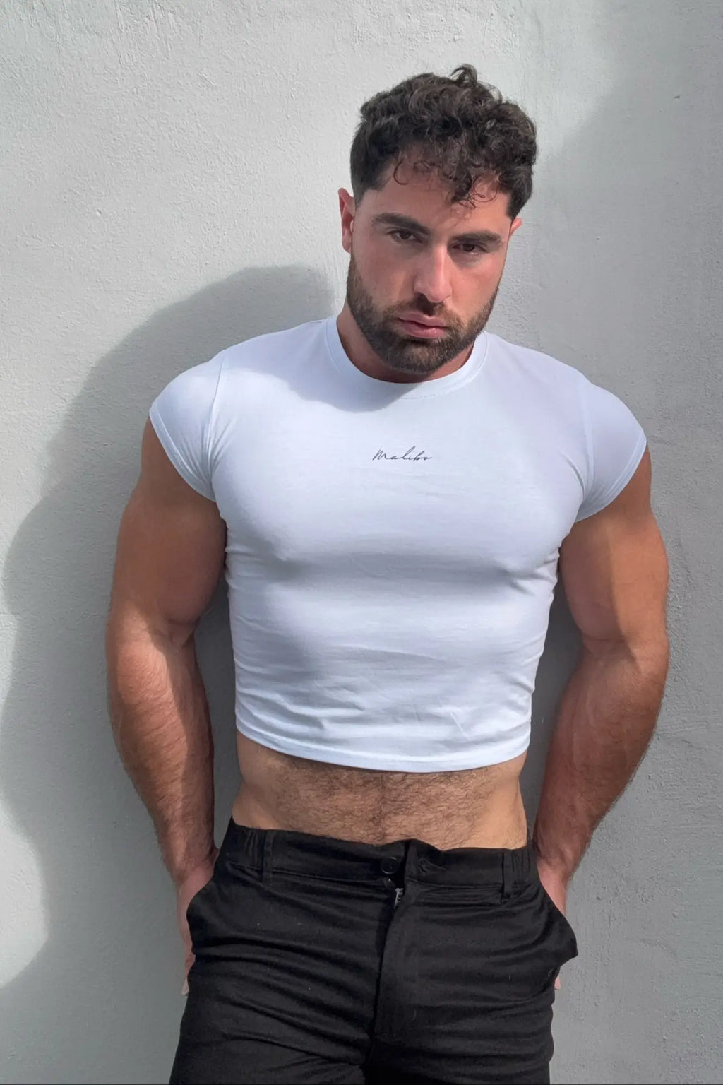 White muscle-fit cropped short-sleeve tee with subtle embroidered logo on chest in breathable cotton material