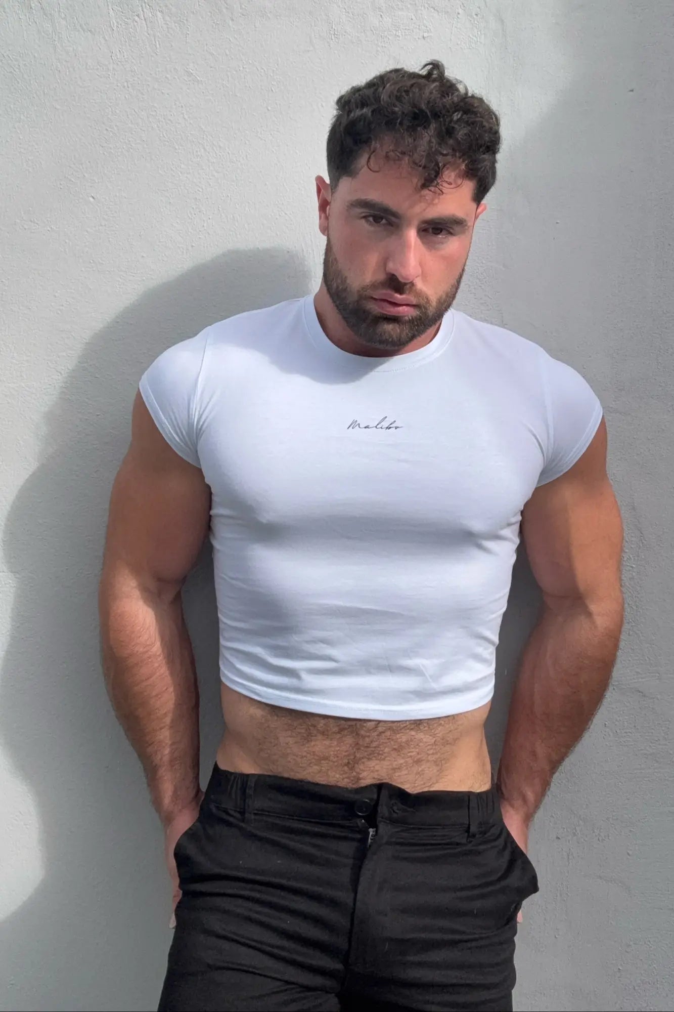White muscle-fit cropped short-sleeve tee with subtle embroidered logo on chest in breathable cotton material