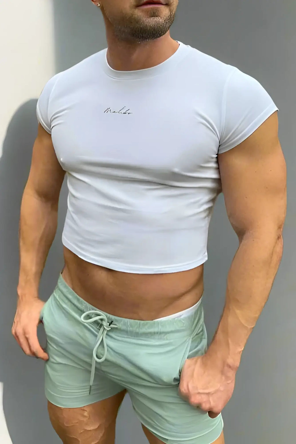 Muscle-fit crop half-sleeve tee in white featuring a subtle embroidered logo on the chest in breathable cotton