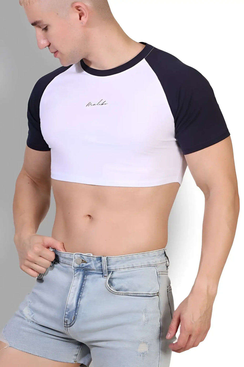 Muscle-fit crop tee with white and black raglan sleeves and subtle embroidered Malibu Script logo on the chest