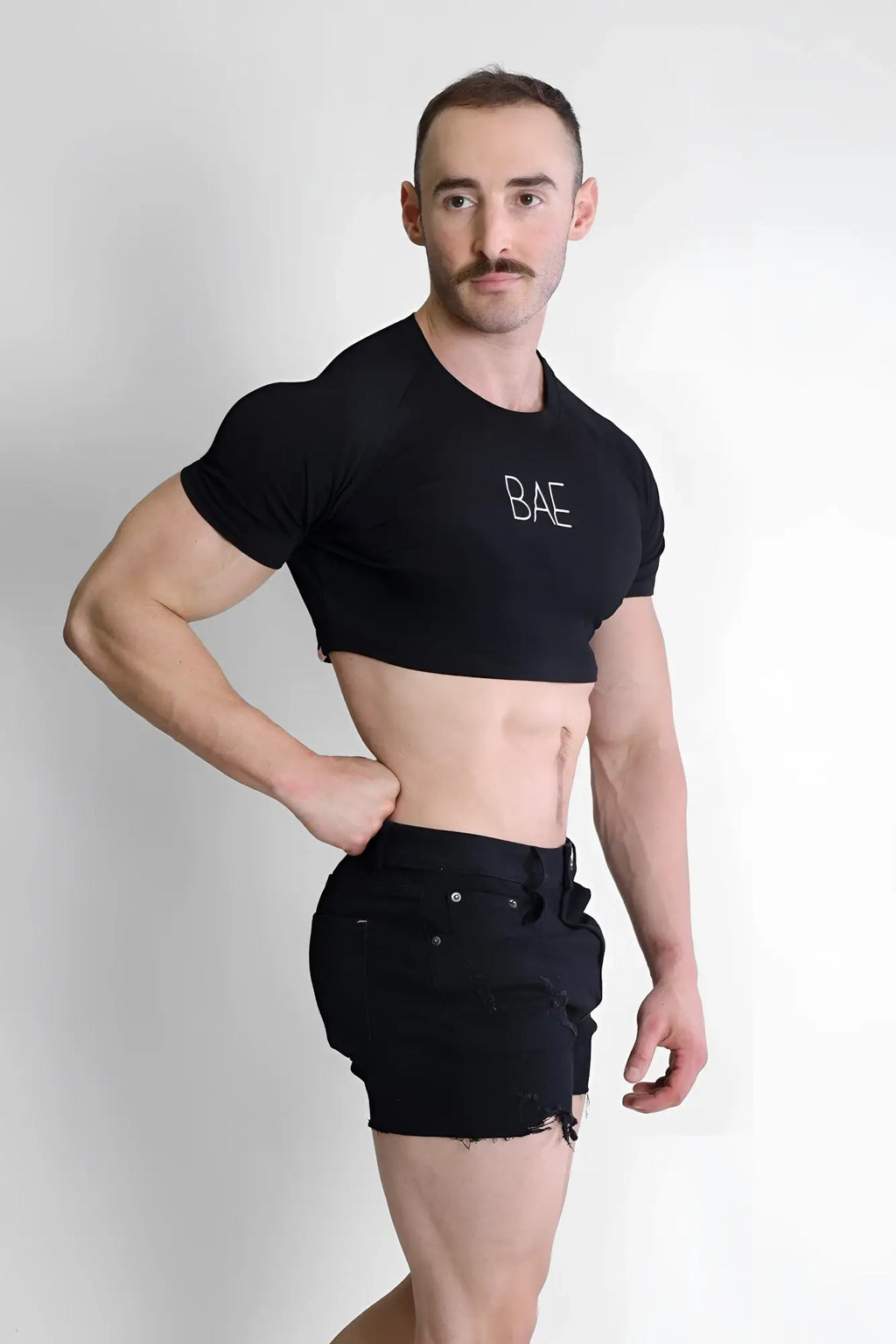 Muscle-fit crop tee in black with bae embroidered in white featuring a cropped fit and soft cotton material