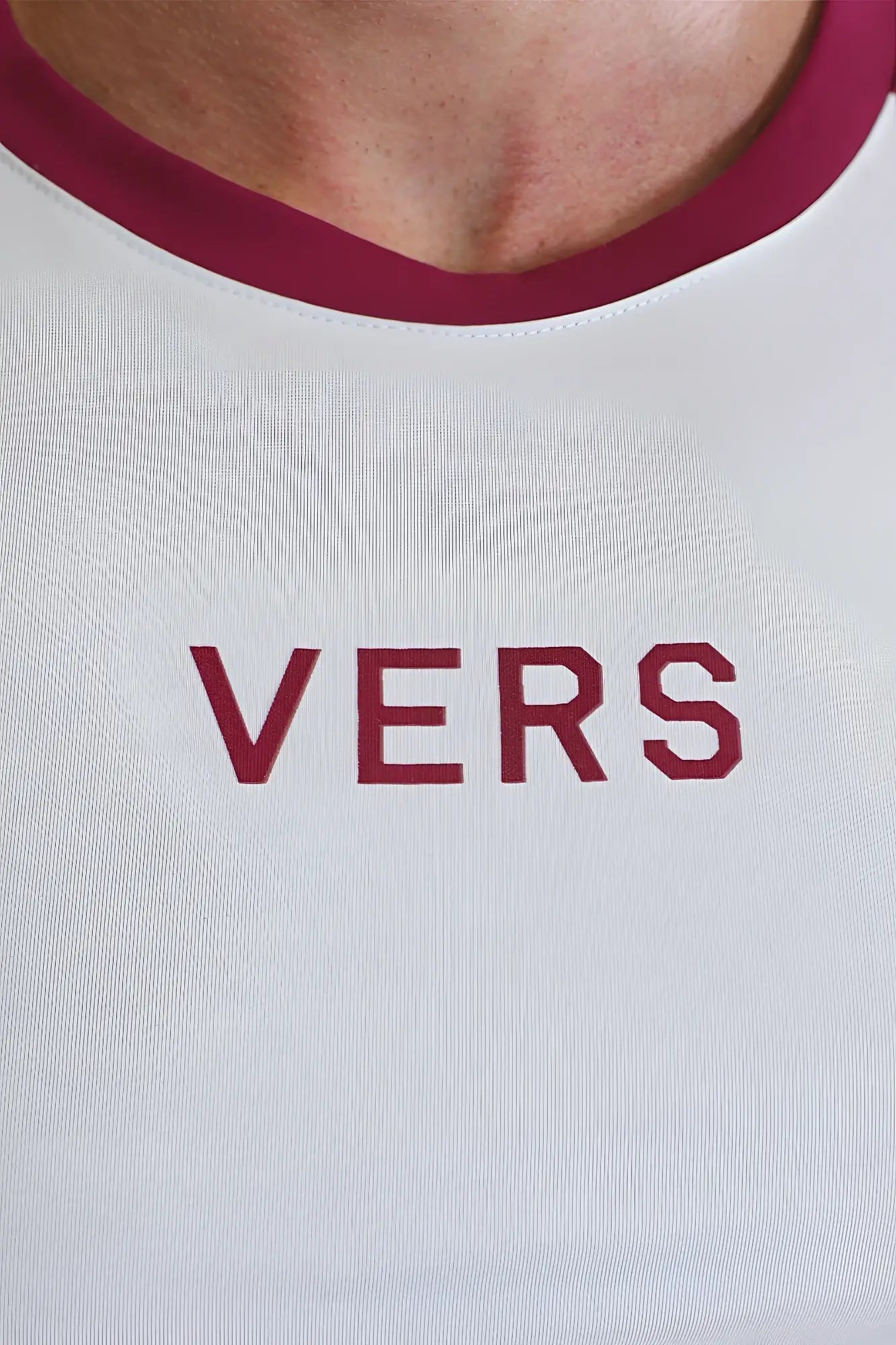 White cotton muscle-fit crop tee with maroon trim and vers logo in matching maroon lettering for versatile wear