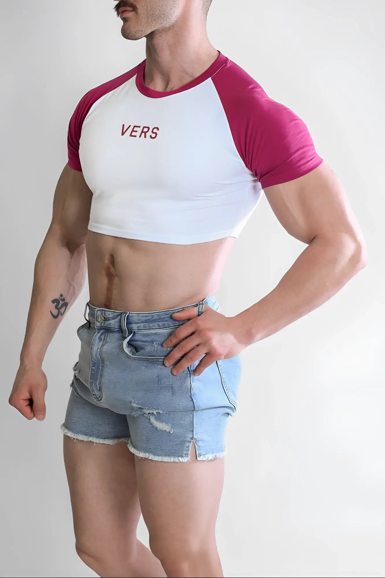 White and magenta muscle-fit crop tee with raglan sleeves and red vers print on chest for versatile wear
