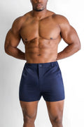 Muscle-fit men’s navy chino shorts with stretchy fabric button closure and subtle side pocket detailing