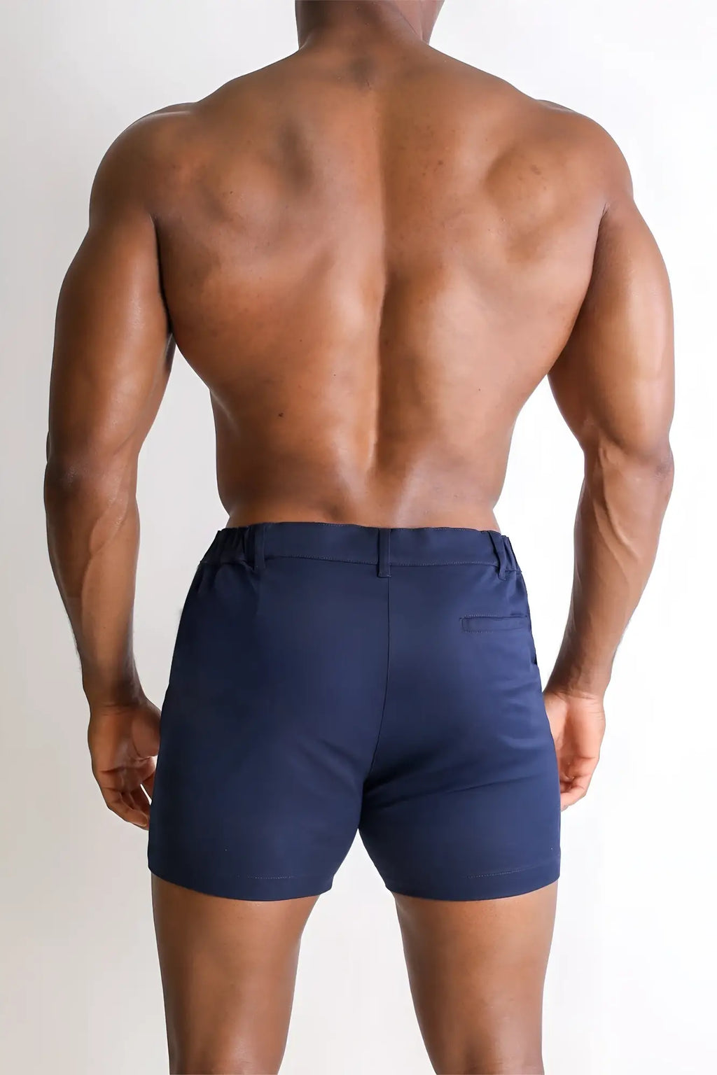 Muscle-fit men’s navy tailored chino shorts with 4 inch inseam stretchy fabric and subtle side pockets