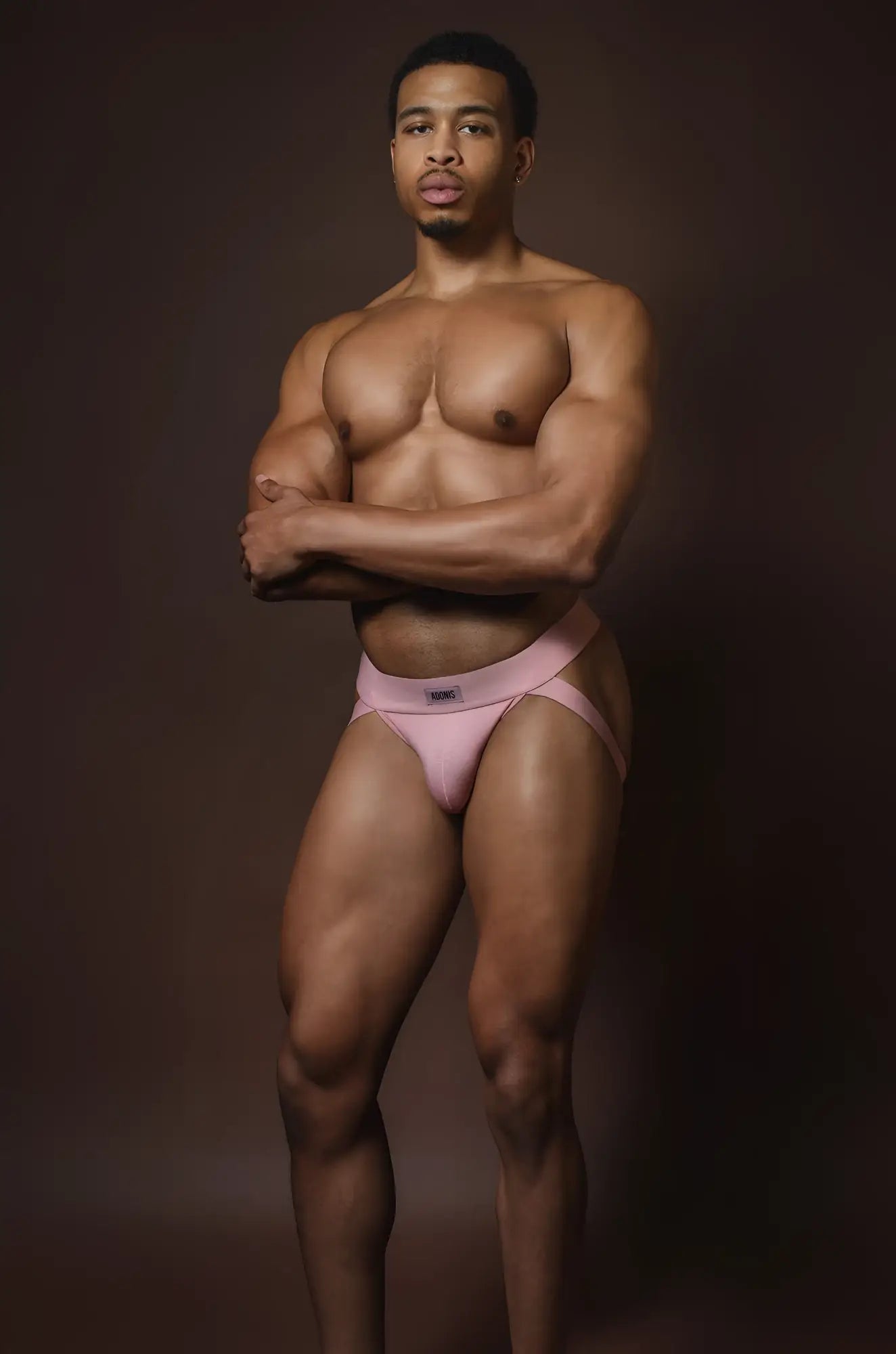 Muted pink jockstrap with a small logo on the waistband designed for athletic support and comfort