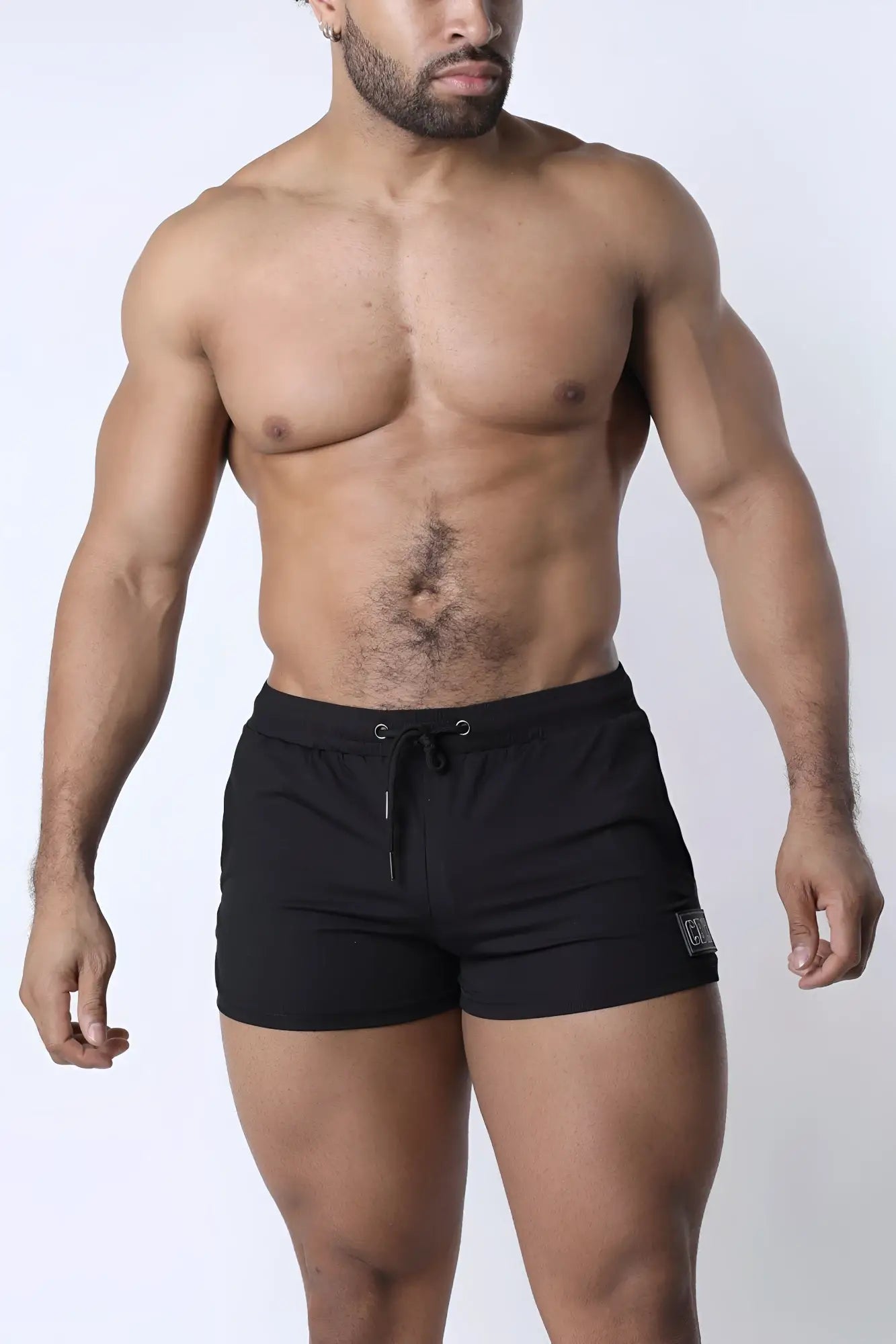 Muzzle Up athletic short in black with drawstring waistband and small logo patch on the lower right leg