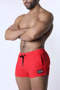 Muzzle up athletic short red with black drawstring and small rectangular patch on the side for active wear