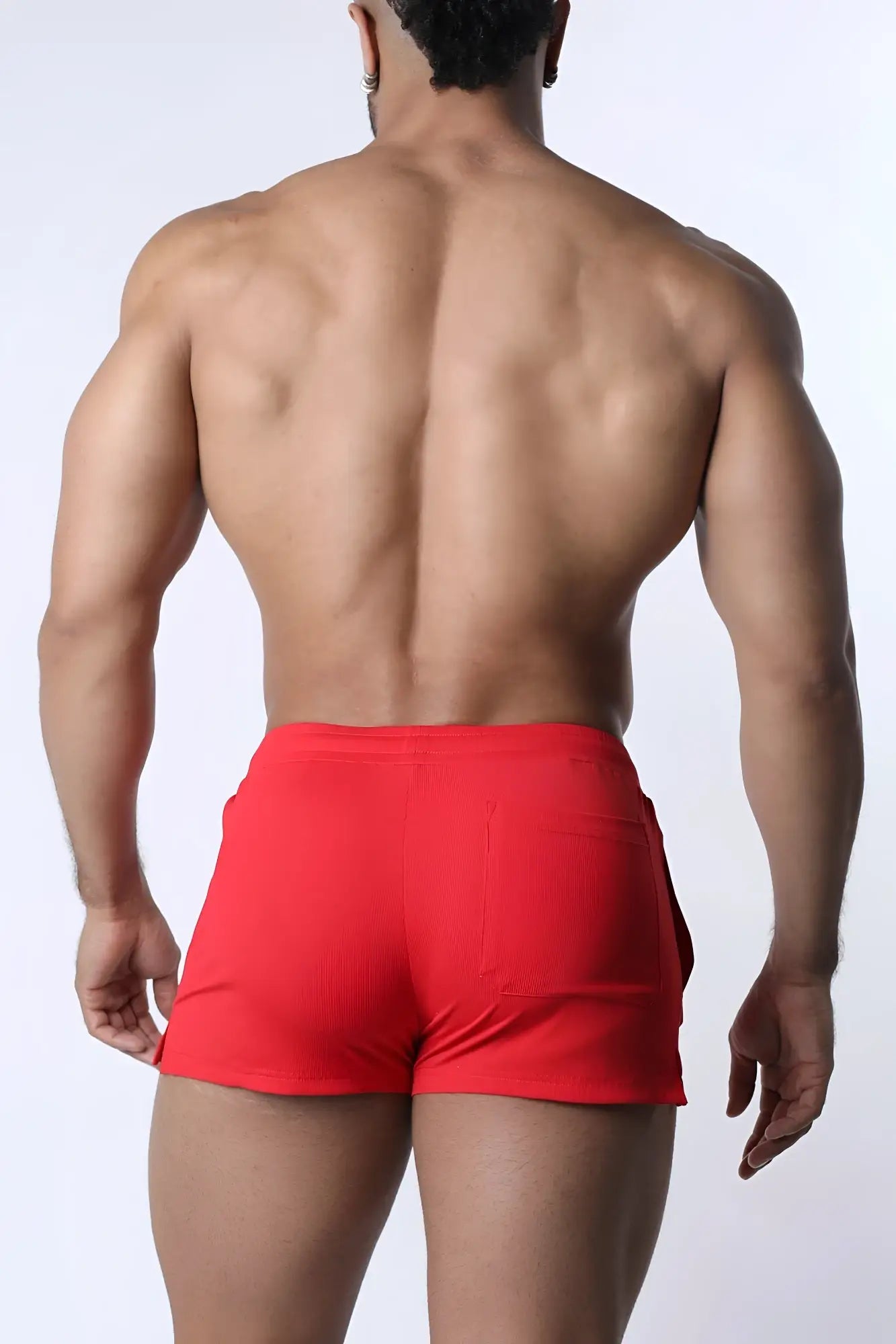 Red muzzle up athletic shorts with ribbed texture and side pockets designed for active wear