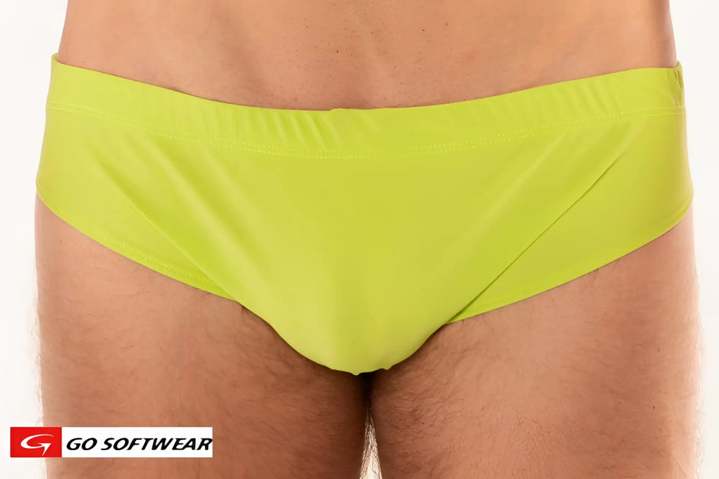 Bright lime green Mykonos bikini swim trunks with smooth form-fitting fabric and simple elastic waistband
