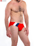 Red Napoli bikini swim trunks with a white and blue diagonal stripe across the front for swimming use