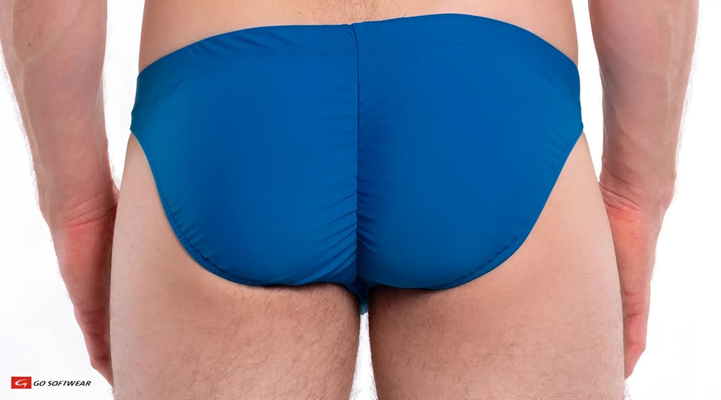 Blue napoli buns bikini swim trunks showing the back with smooth form-fitting fabric and central seam detail