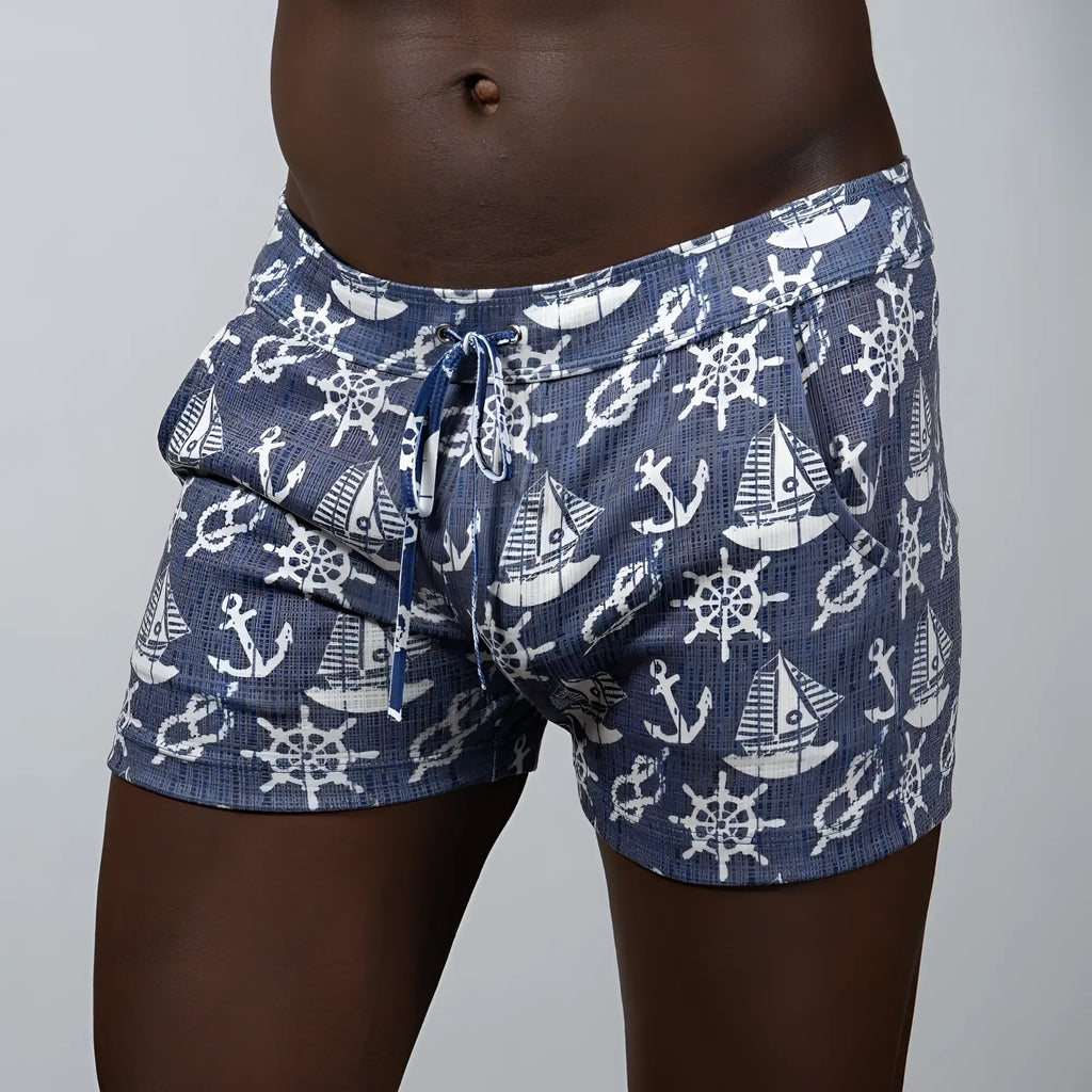 Nautical linen texture shorts in navy blue fabric with white anchor and ship wheel patterns and elastic waistband