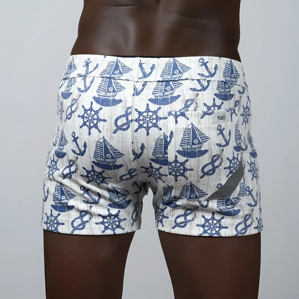 White linen texture swim trunks with navy blue nautical sailboat anchor and ship wheel pattern