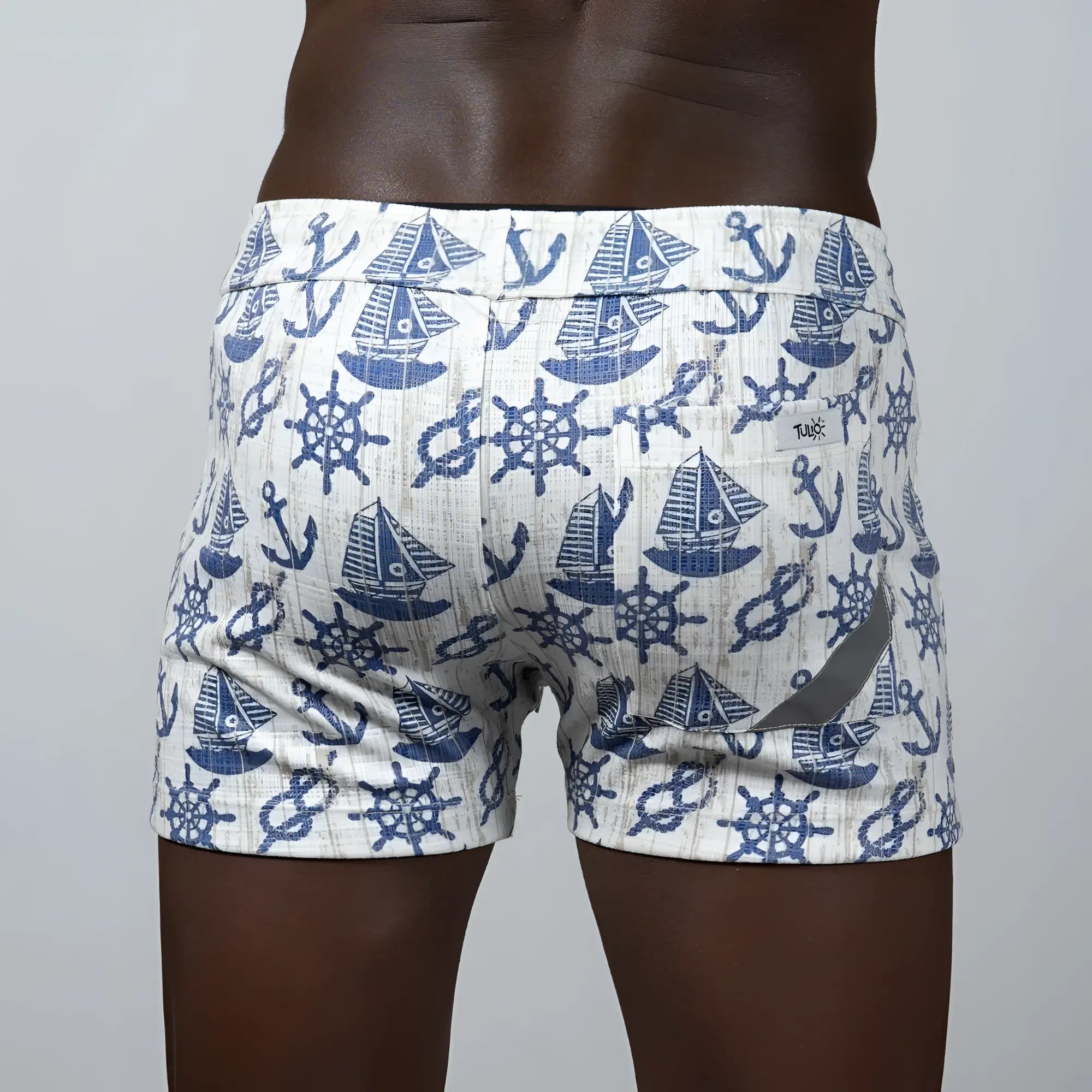White linen texture swim trunks with navy blue nautical sailboat anchor and ship wheel pattern