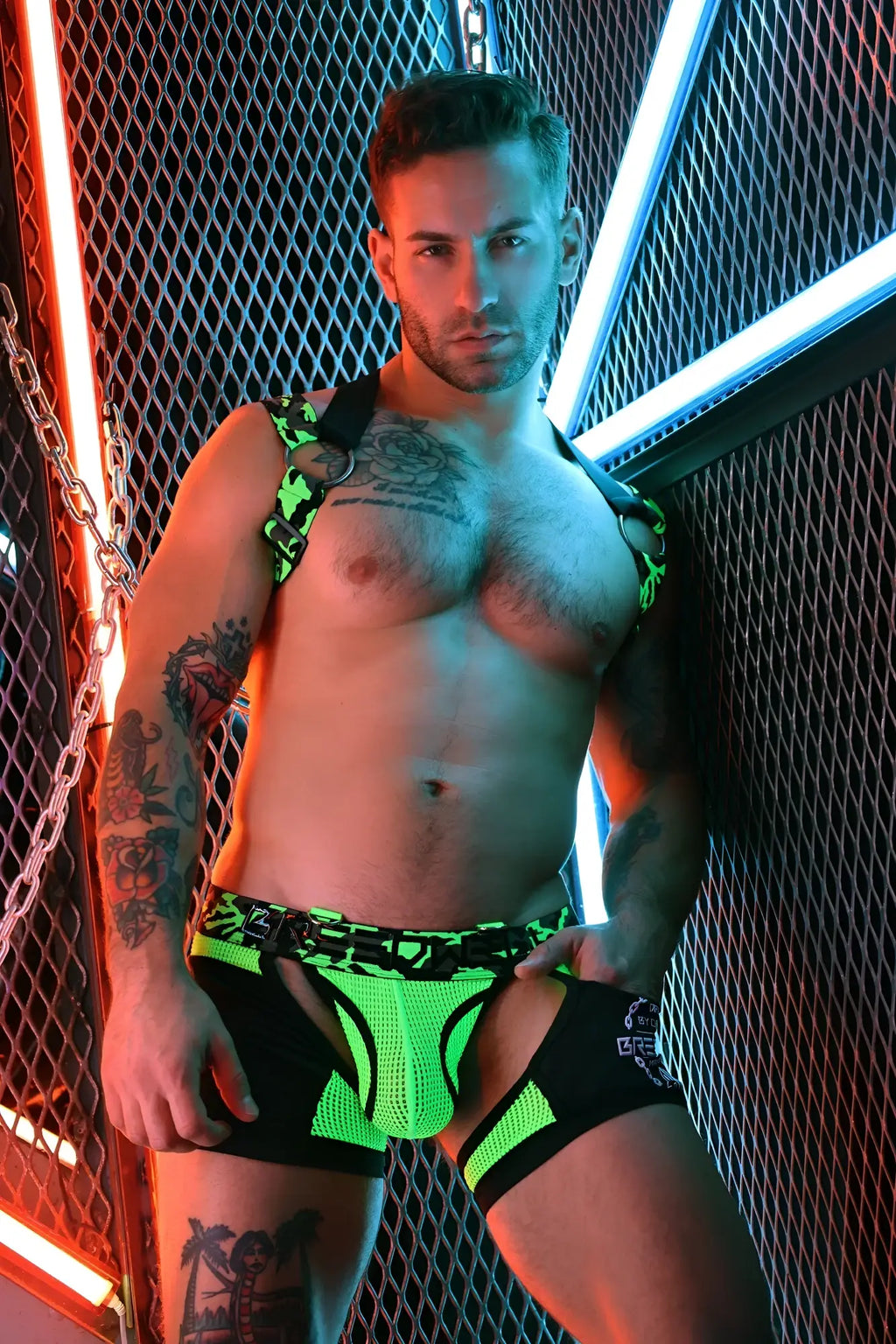 Neon green and black mesh briefs with bold edgy design in neo camo 3-way harness style front view