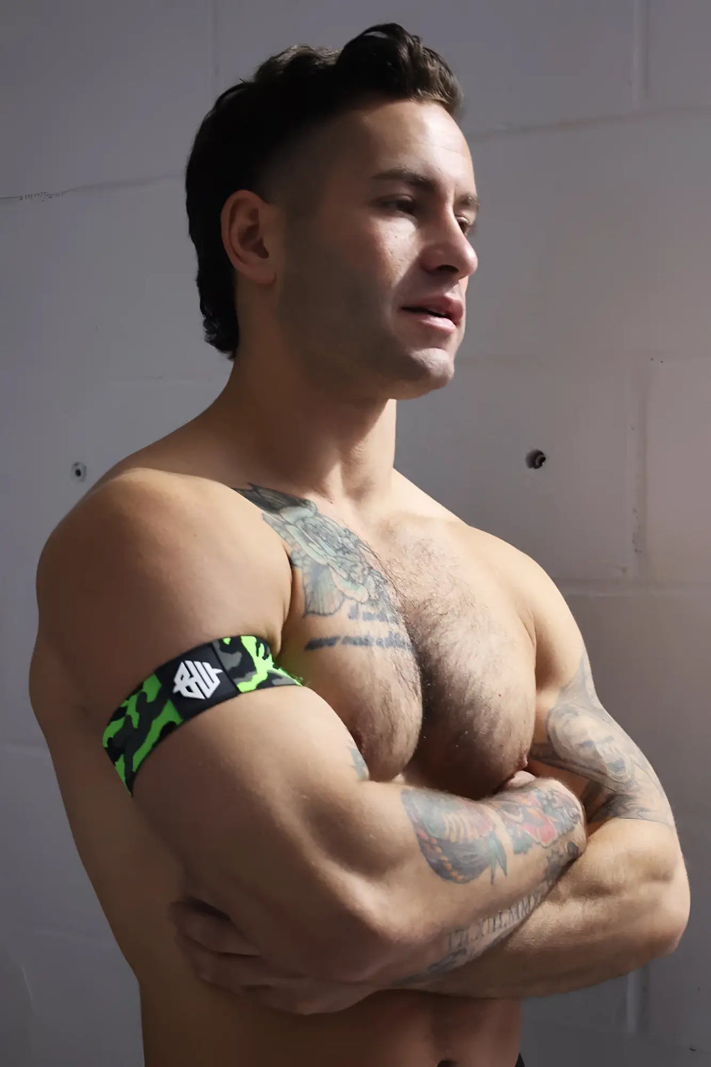 Neo camo armband in neon green and black camouflage pattern with a white logo on a fabric armband
