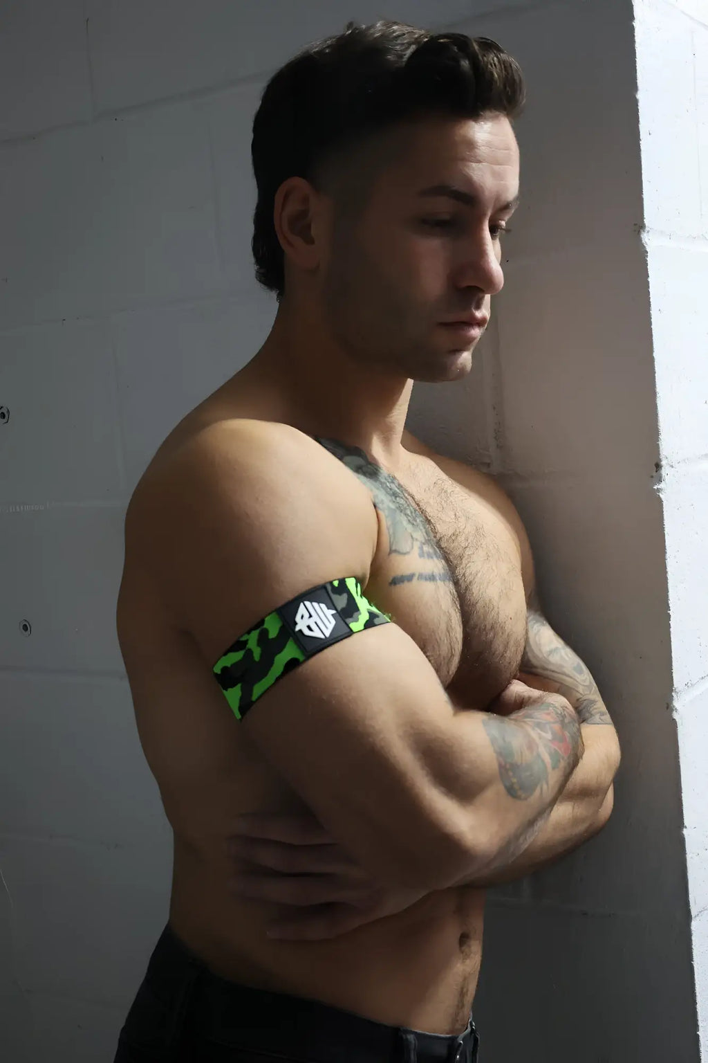 Neo camo armband featuring neon green and black camouflage pattern with a white logo on a durable fabric band