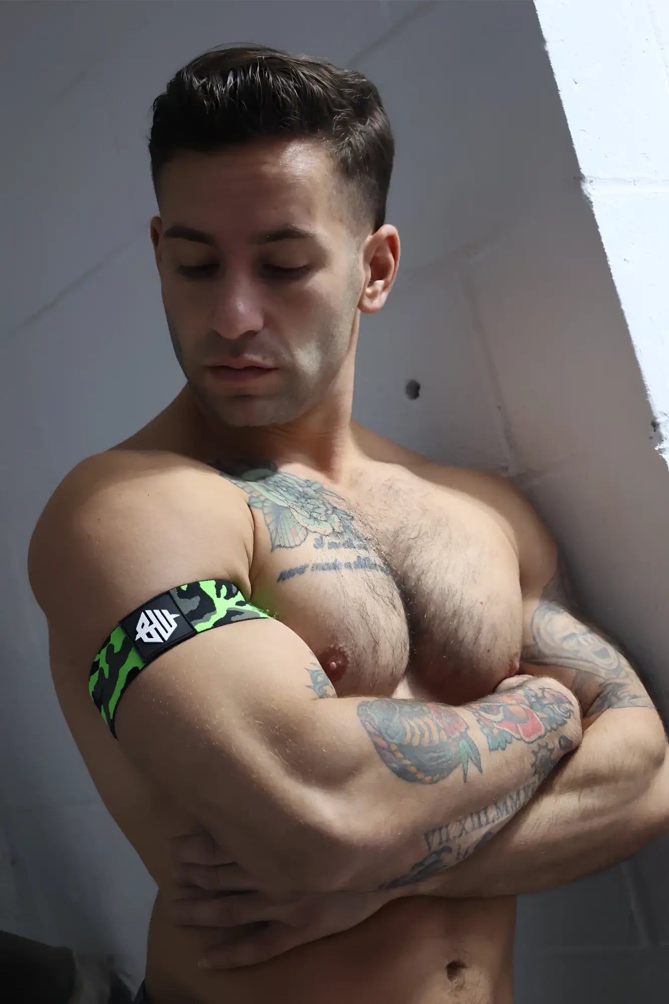 Neo camo armband with neon green and black camouflage pattern and a white logo on a durable fabric band