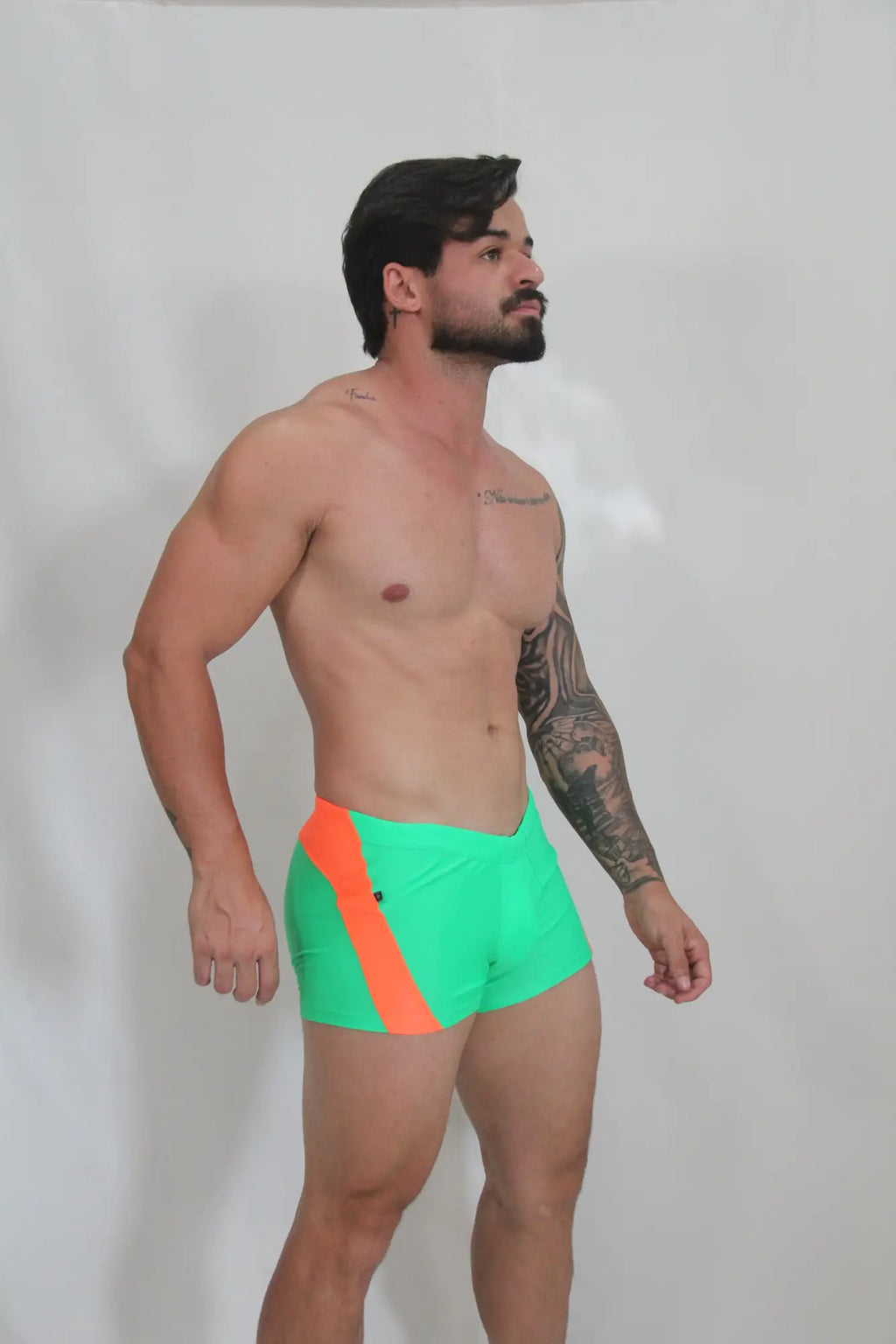 Neon curved sq cut trunk vibrant neon green swim trunks with bold orange diagonal stripe for swimwear use