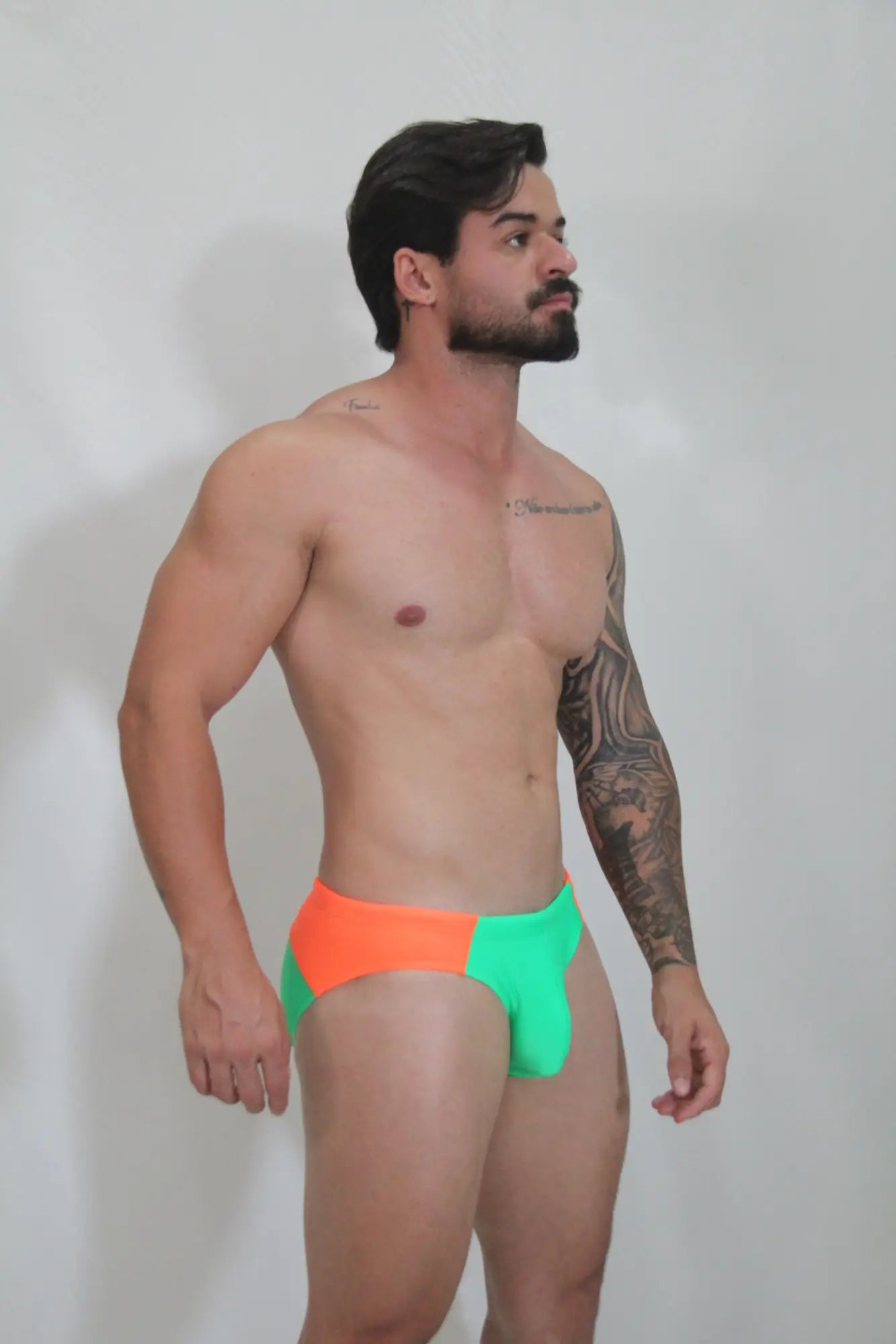 Neon curved swim brief with vibrant two-tone neon orange and electric green colors and sleek modern cut for swimming