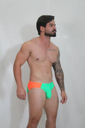 Neon curved swim brief featuring vibrant two-tone neon orange and lime green with a sleek modern cut