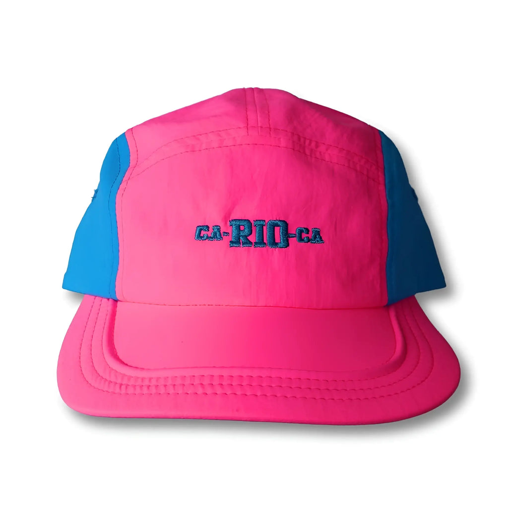 A vibrant pink and blue neon dream bike cap hat featuring teal ca-rio-ca embroidery on the front