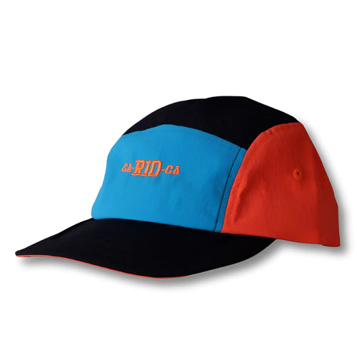 A vibrant neon dream bike cap hat with a black crown, bright blue front, red sides, and orange da-rid-ga embroidery