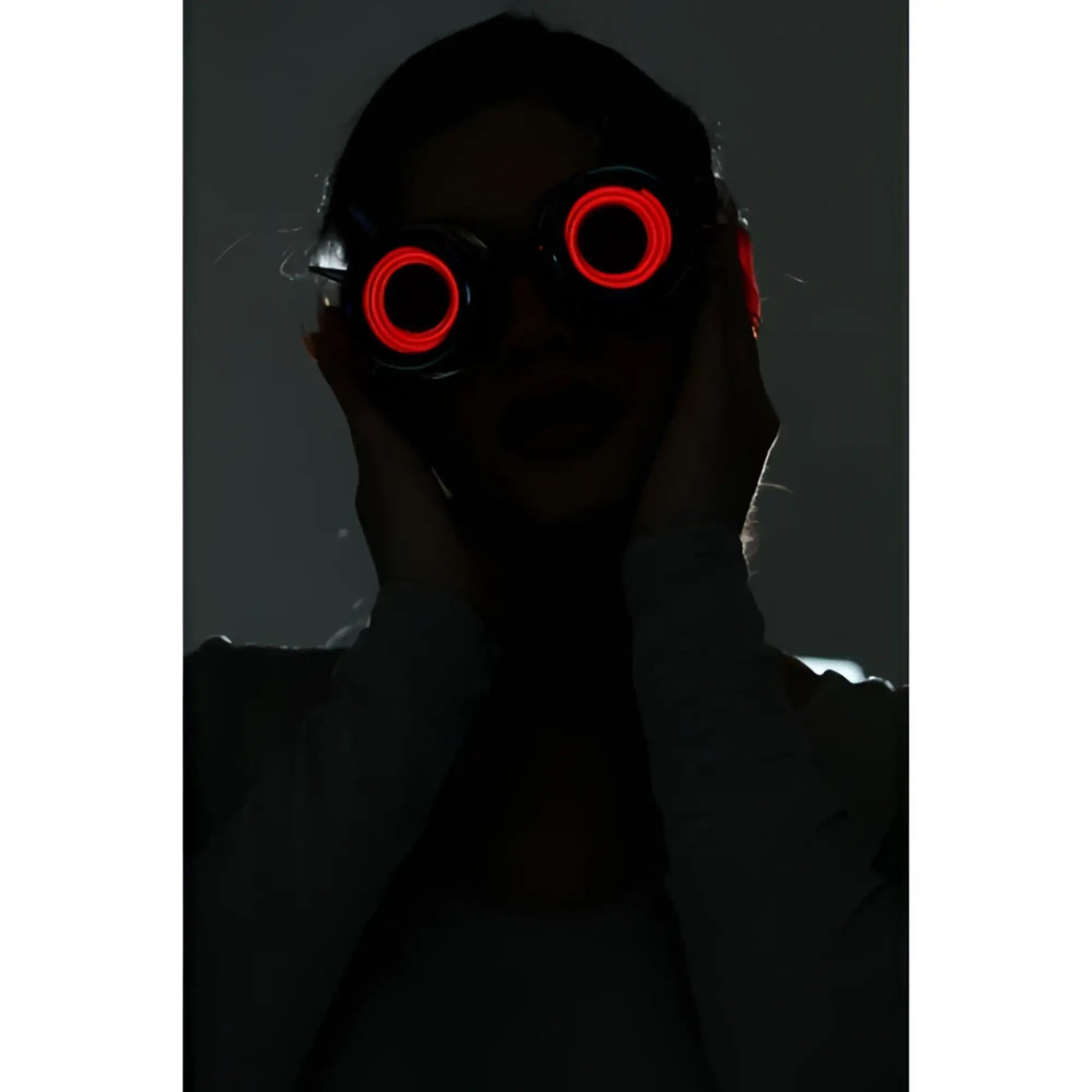 Red led-lit neon light up goggles with circular glowing lenses designed for vibrant night use