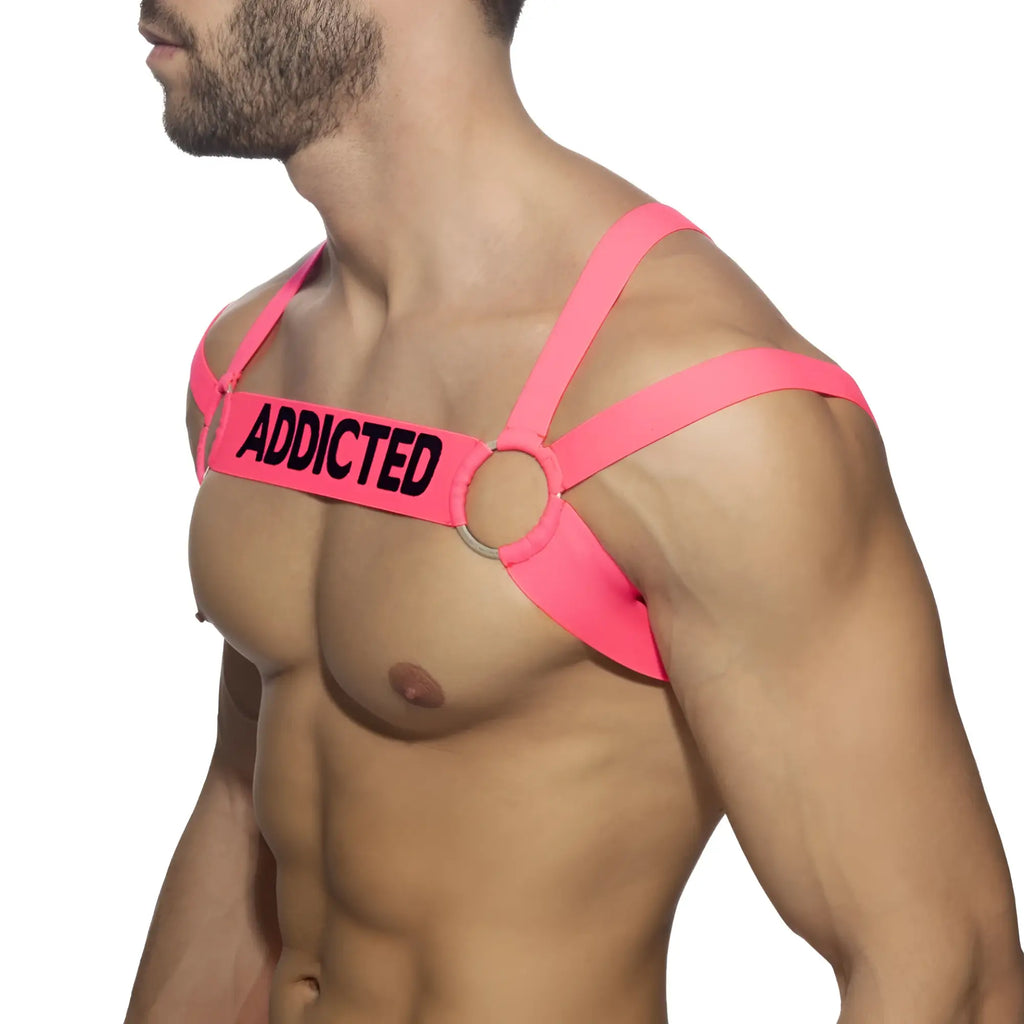 Bright pink neon multi band harness with black addicted lettering on chest strap for edgy fashion statement