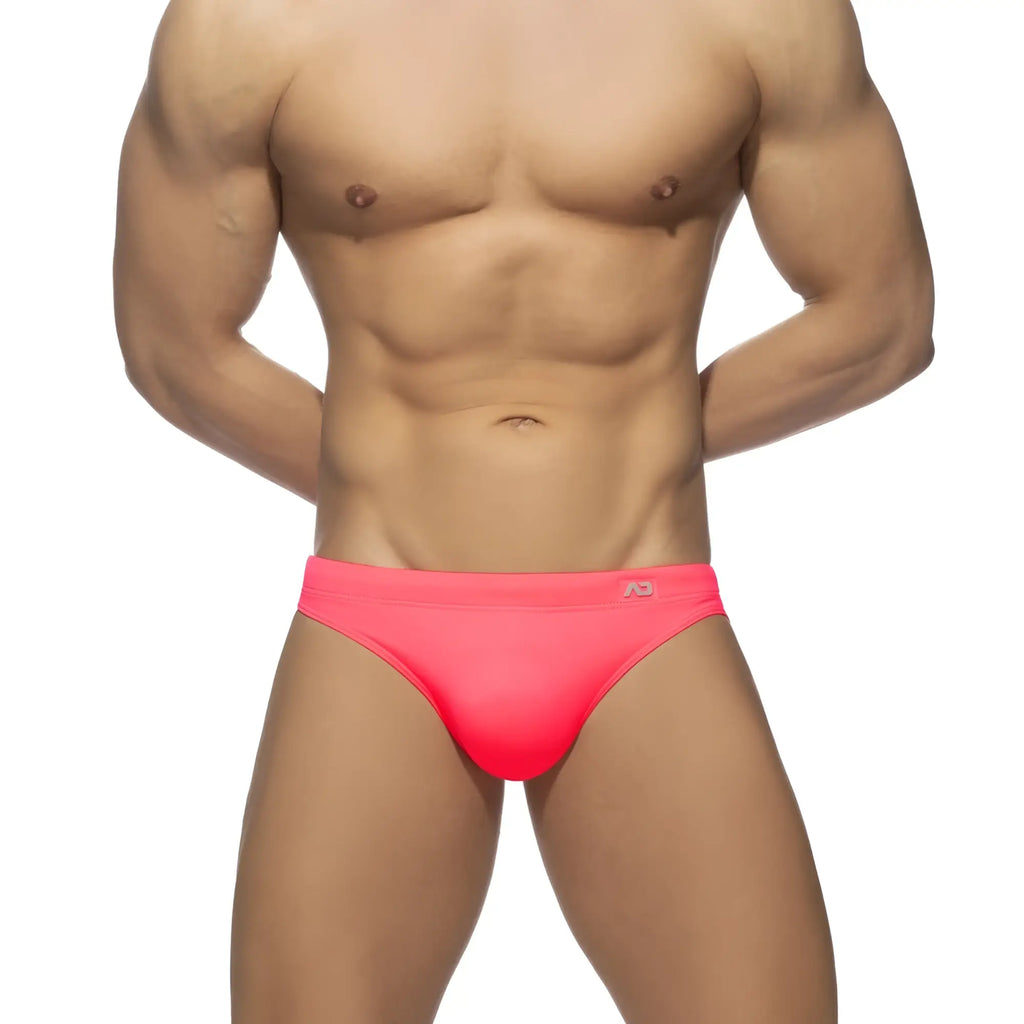 Neon swim bikini bright pink swim trunks with snug form-fitting design and small logo on waistband