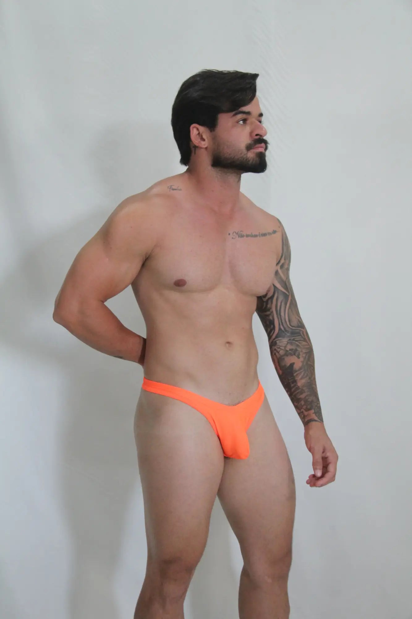 Bright orange neon swim thong with sleek minimalist design perfect for vibrant beachwear options