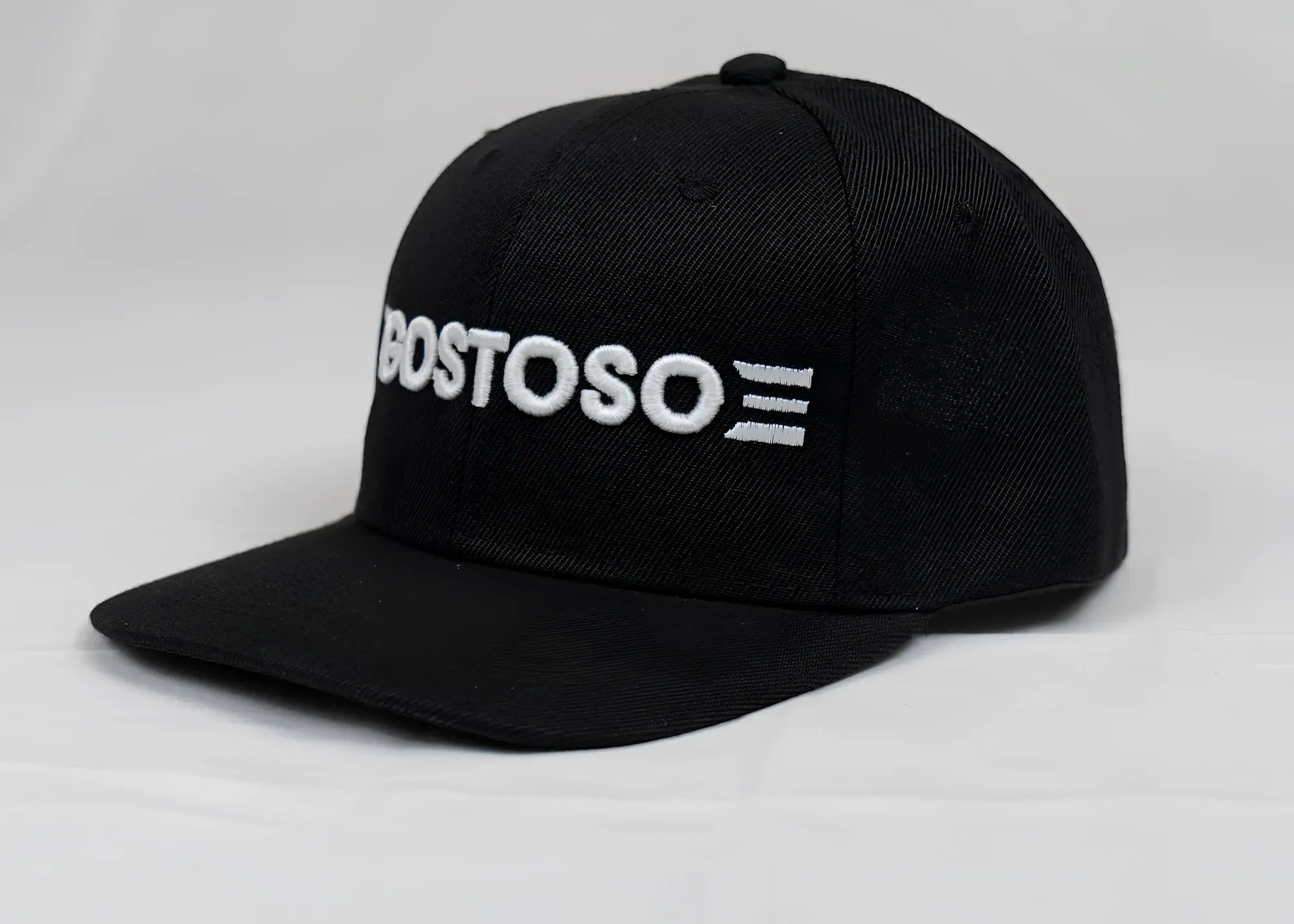 Black snapback cap with white 3d puff bostoso embroidered logo and three horizontal stripes on front panel