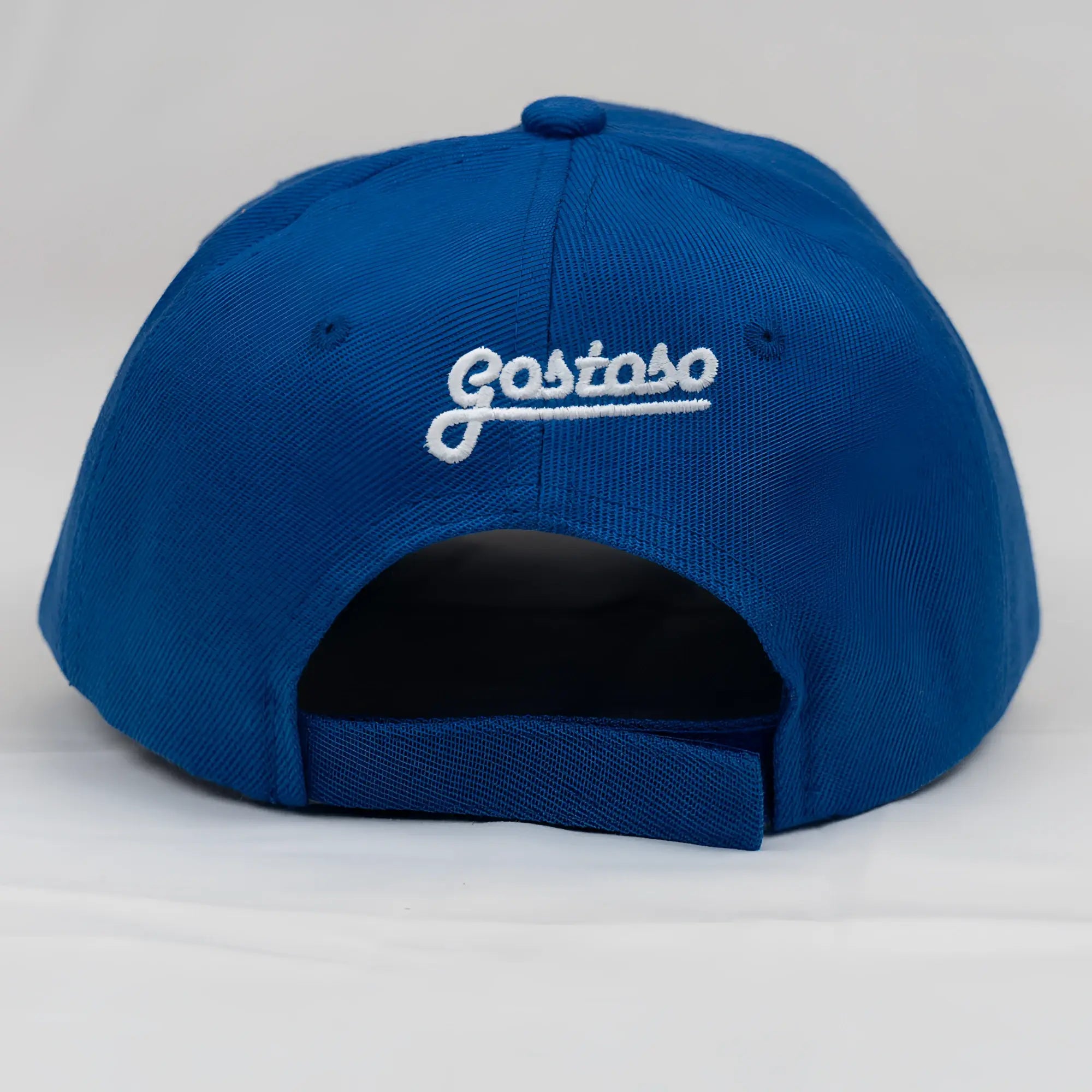 Vibrant royal blue baseball cap with white 3d puff gostoso stripes logo embroidered on the back side