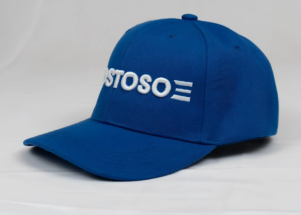 A vibrant royal blue baseball cap featuring white embroidered ostoso lettering and a 3D puff stripes logo