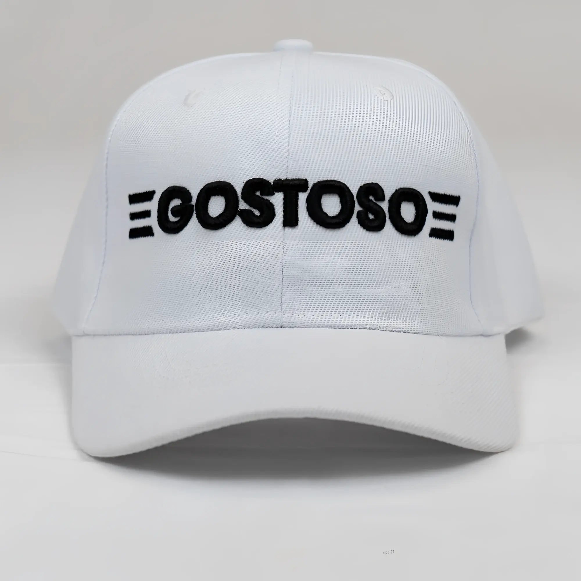 White baseball cap with black 3D puff gostoso logo and six horizontal stripes embroidered on front panel