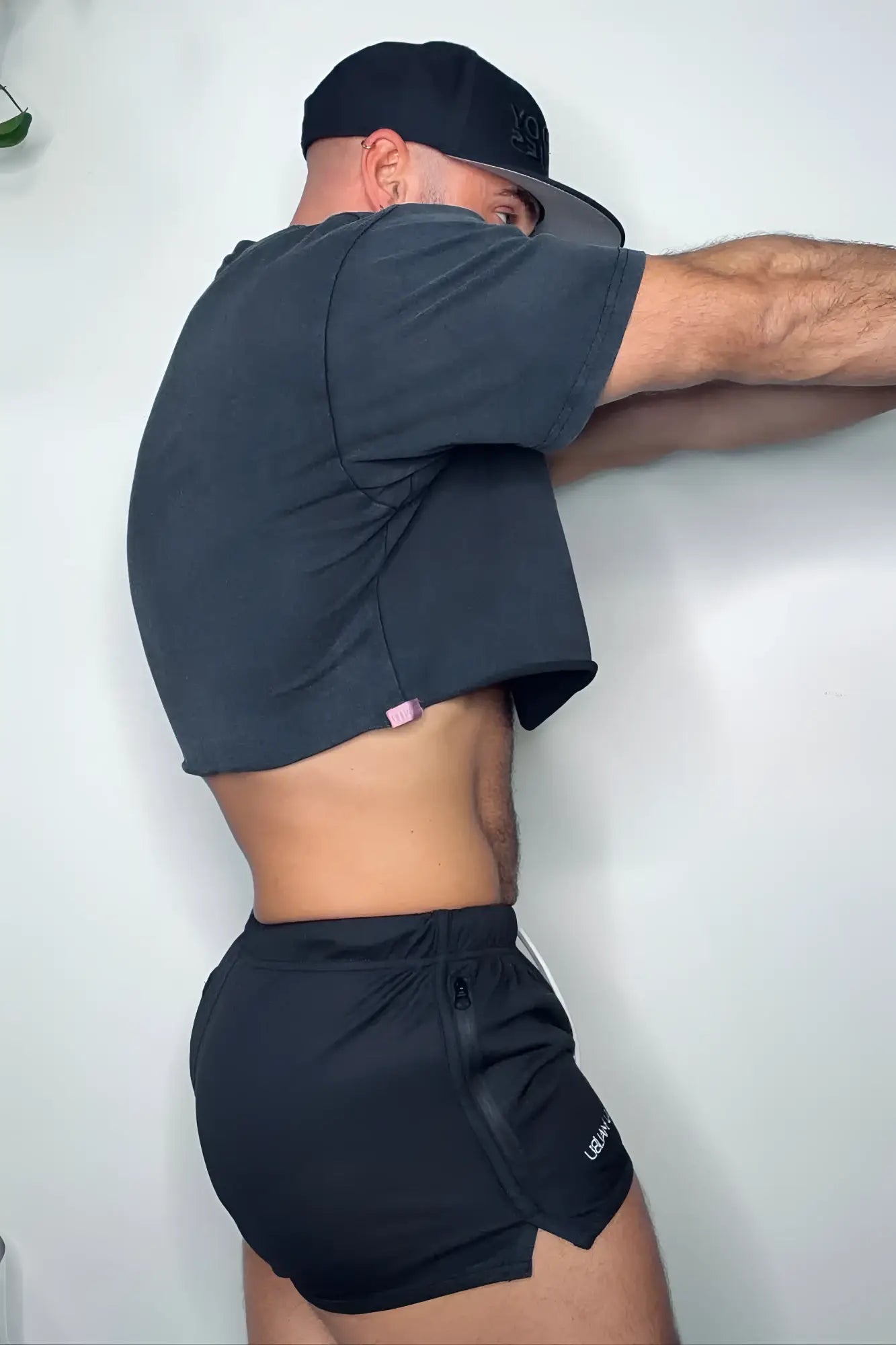 Black cropped t-shirt with small pink side tag paired with obsidian black For-the-Night 2 gym short shorts with drawstring