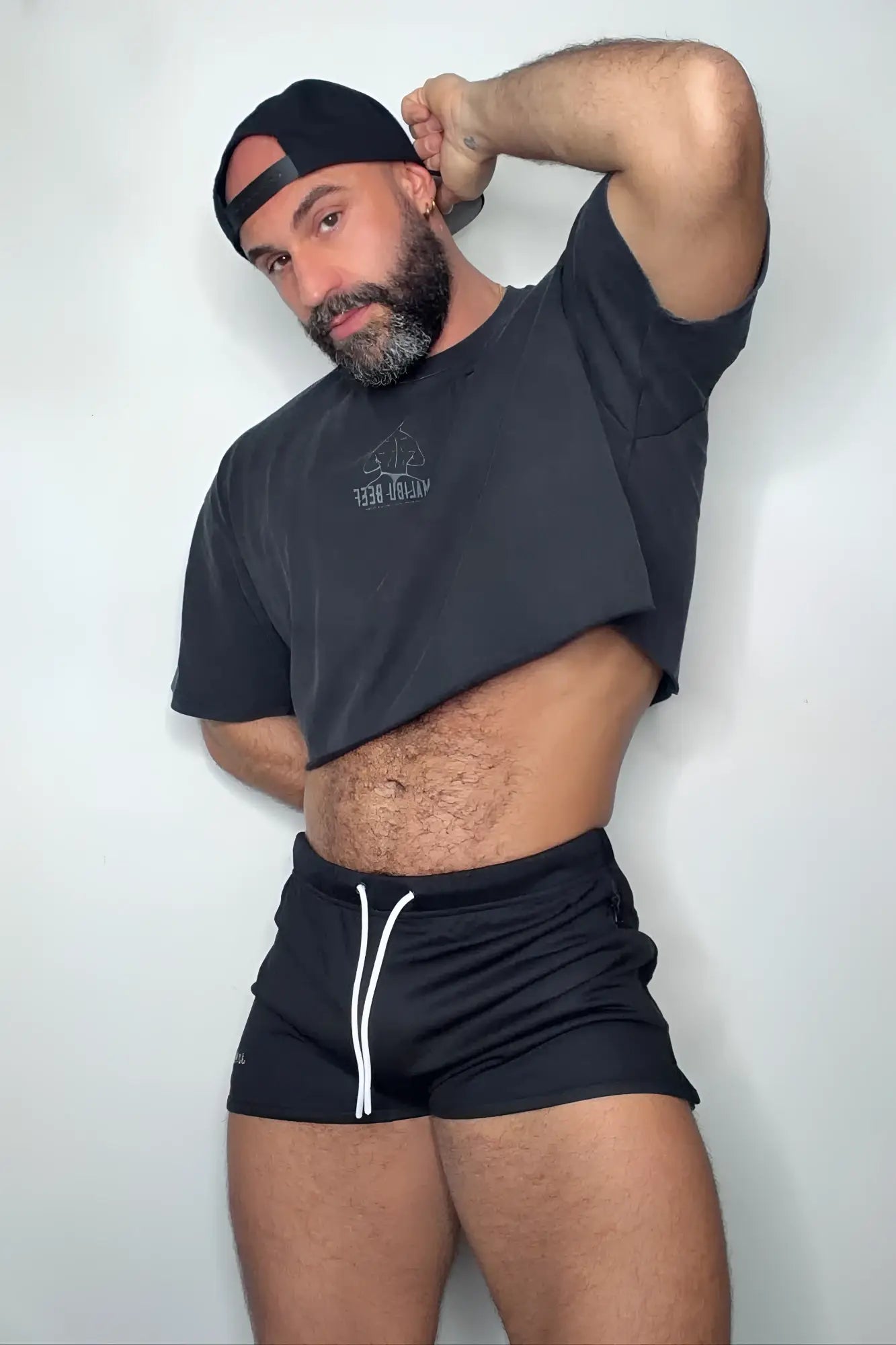 Black cropped t-shirt with small white logo paired with obsidian black for-the-night 2 inch gym short shorts with drawstring