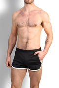 Nightcall elastic waist 3 inch short shorts in midnight black with white trim on hem and side seams for athletic use