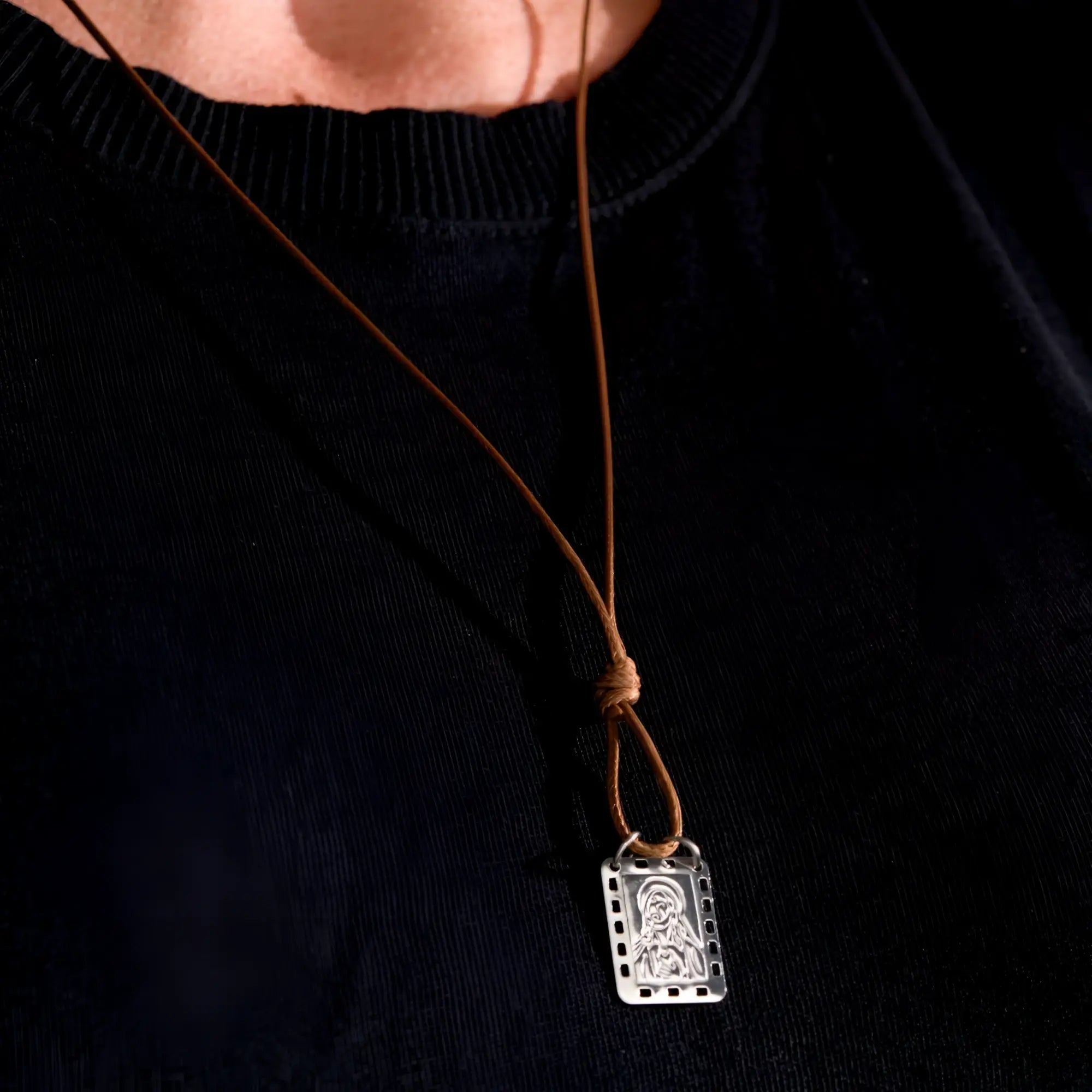 Silver rectangular pendant with filmstrip design and engraved nossa senhora do carmo on brown leather cord men’s necklace