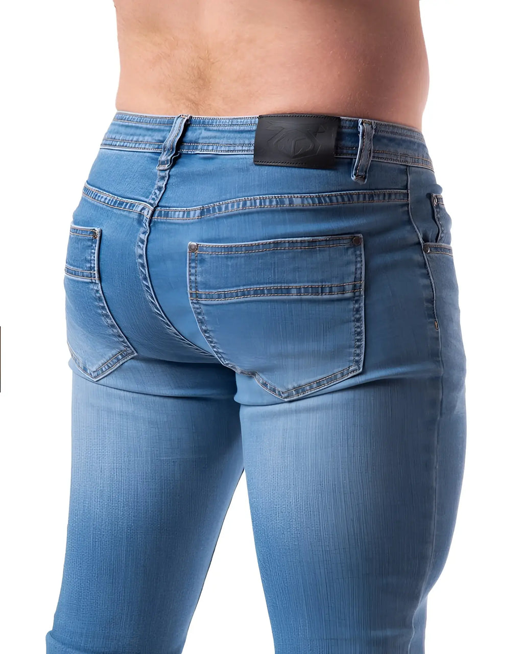 Blue denim jeans with a black leather brand patch on the waistband shown from the back in NP JEAN product image